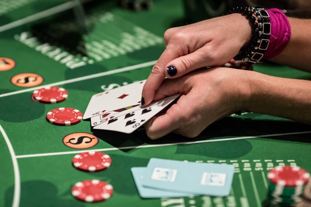 Card player showing card hands at a blackjack table
