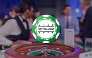 Green poker chip graphic with Event Planning written on it over background picture of roulette wheel in focus at event