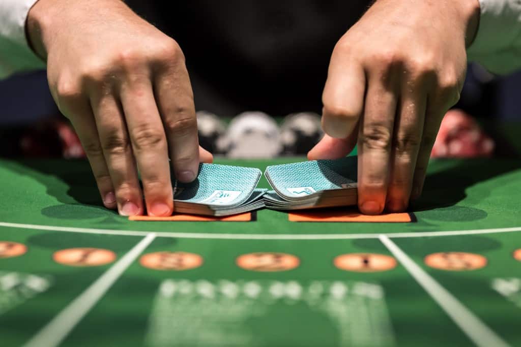 closeup of hands shuffling deck of cards