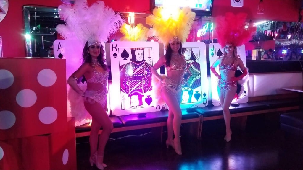 showgirls next to giant dice and playing cards